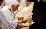 El Papa Benedicto XVI dando la Sagrada Eucaristia de rodillas y en la boca